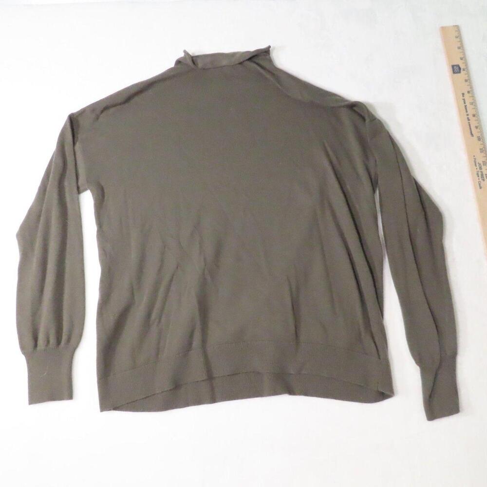 The Treasure & Bond Mock Neck Sweater in Olive Green is a stylish and cozy addit